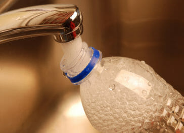 hard tap water filling bottle from faucet