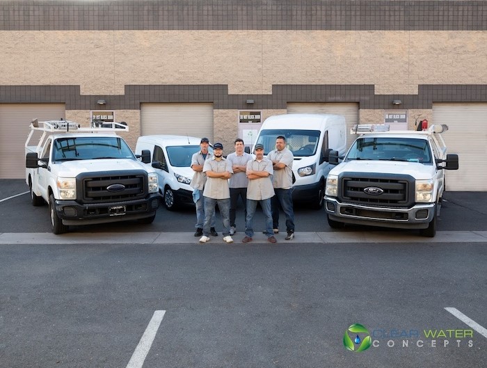 Clear Water Concepts team standing in front of service vehicles in Arizona