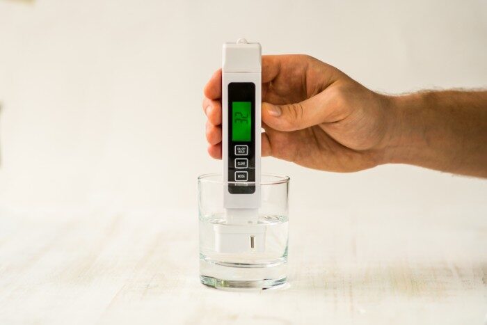 A professional digital water hardness tester measuring mineral content in water
