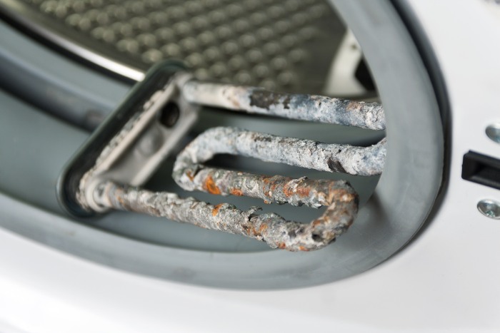 Corroded heating element showing severe limescale deposits due to water hardness