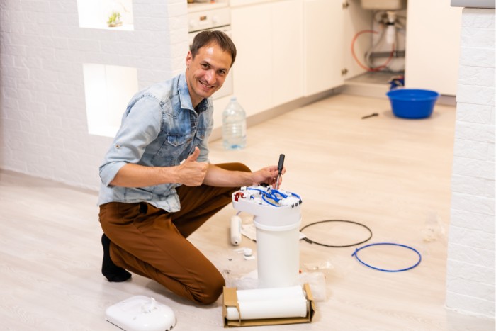Technician installing a water filter to complement a softener system