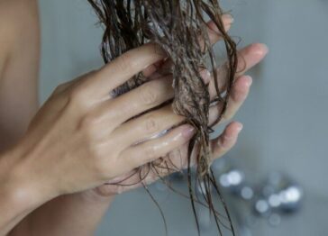 Hands moisturizing hair after washing with hard water