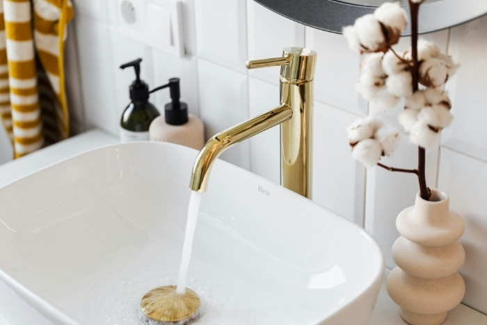 Reduced scale bathroom faucet after salt-free water conditioning system installation in Phoenix