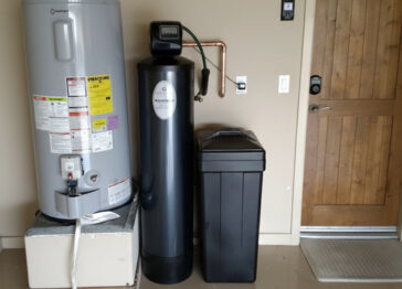 Water softener system with brine tank installed in a home utility space