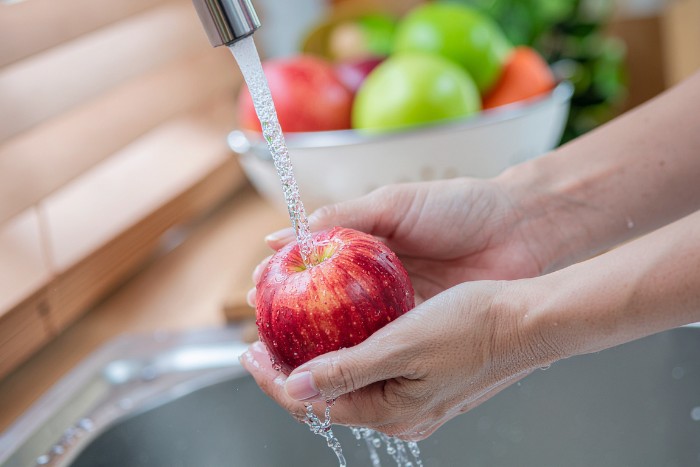 Washing fresh fruit with softened and filtered well tap water in a Phoenix home