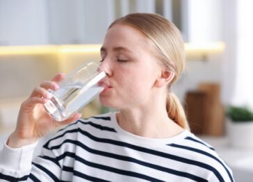 Woman drinking hard water in a Phoenix home