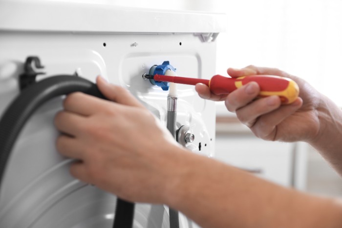 Maintenance work on commercial equipment damaged by scale from untreated hard water